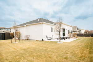 Rear view of house featuring a patio area, and fence