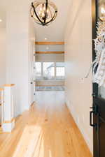 Corridor featuring recessed lighting, an upstairs landing, and wood finished floors.