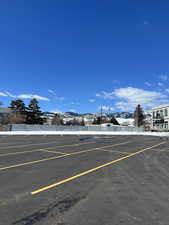 Uncovered parking lot featuring a mountain view