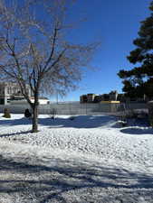 Snowy yard with fence