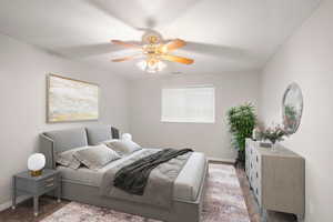 Carpeted bedroom with a textured ceiling and ceiling fan