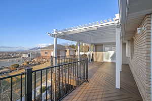 Wooden deck with a mountain view and a pergola