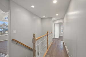 Corridor featuring dark wood-type flooring