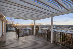 Snow covered deck with a pergola