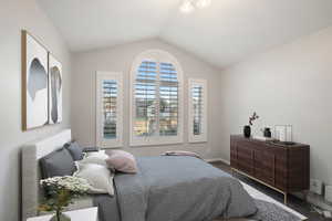 Carpeted bedroom with vaulted ceiling