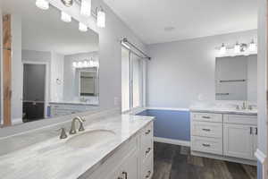 Bathroom with hardwood / wood-style flooring and vanity