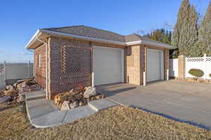 View of front of property with an outbuilding and a garage