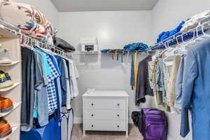 Master Closet that is very spacious with carpet floors