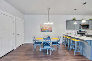 Dining room with baseboards, visible vents, and dark wood-style flooring