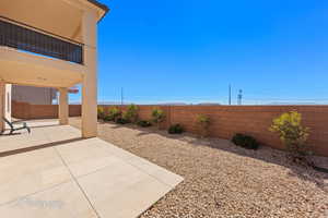 View of yard featuring a fenced backyard and a patio