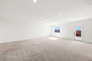 Unfurnished room with recessed lighting, baseboards, and light colored carpet