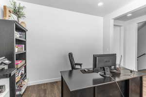 Office space with dark wood-type flooring, recessed lighting, and baseboards