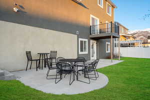 View of patio with visible vents, a mountain view, fence, and a balcony