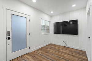 Interior space featuring baseboards, wood finished floors, and recessed lighting