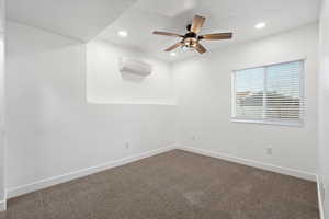 Carpeted empty room with recessed lighting, a wall mounted air conditioner, ceiling fan, and baseboards