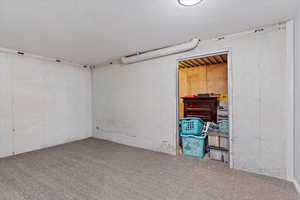 Empty room with a textured ceiling and carpet