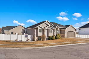 View of front facade with fence private yard and stucco siding