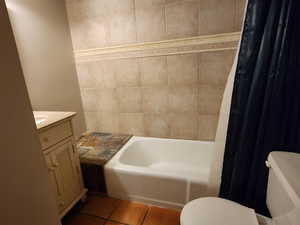 Bathroom featuring toilet, tile patterned floors, and vanity