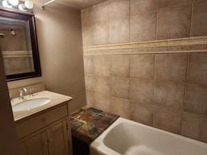 Bathroom with a washtub and vanity