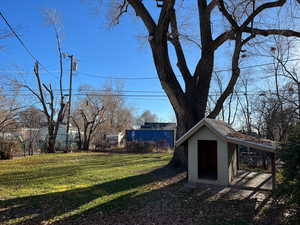 View of yard featuring a storage shed and an outbuilding