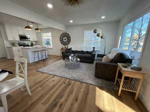 Living area featuring recessed lighting, baseboards, and light wood finished floors