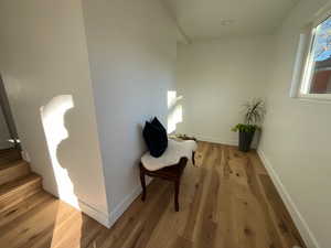 Living area featuring stairway, wood finished floors, and baseboards