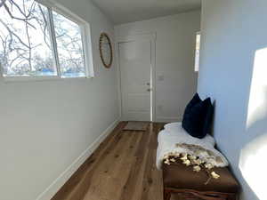 Hall featuring wood-type flooring and baseboards