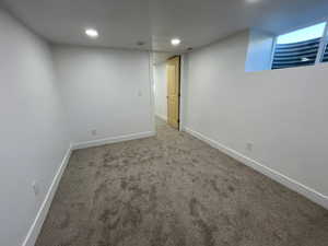 Finished below grade area with recessed lighting, carpet, and baseboards