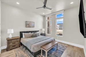 Bedroom featuring light wood-style floors, recessed lighting, visible vents, and baseboards