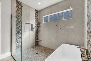 Bathroom with a soaking tub and walk in shower