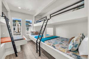 Bedroom featuring a textured ceiling, wood finished floors, and visible vents