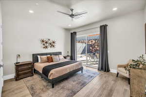 Bedroom with light wood-style floors, access to outside, and baseboards