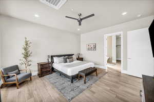 Bedroom featuring visible vents, baseboards, ceiling fan, light wood-style floors, and recessed lighting