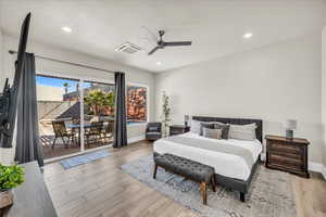 Bedroom featuring light wood finished floors, recessed lighting, visible vents, access to outside, and baseboards