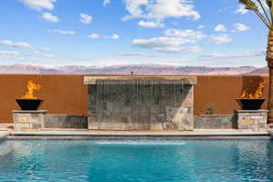 View of swimming pool with a mountain view and a fenced in pool