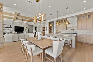 Dining room featuring visible vents, coffered ceiling, light wood-type flooring, beam ceiling, and recessed lighting