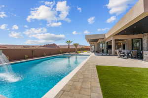 View of pool with a fenced backyard, ceiling fan, and a patio