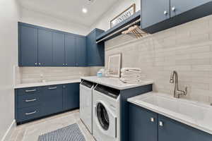 Laundry room with cabinet space, visible vents, independent washer and dryer, a sink, and recessed lighting