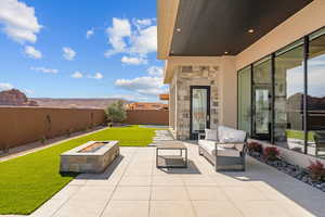 View of patio featuring an outdoor living space with a fire pit and a fenced backyard