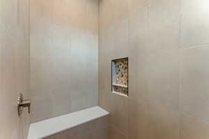 Full bathroom featuring tiled shower