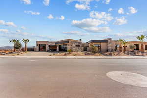 View of front of property with a garage, driveway, and stucco siding