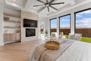 Bedroom featuring access to exterior, beam ceiling, recessed lighting, a premium fireplace, and light wood-style floors