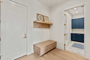 Mudroom featuring baseboards, light wood-type flooring, and recessed lighting