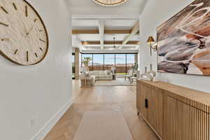 Hall with beam ceiling, coffered ceiling, and baseboards