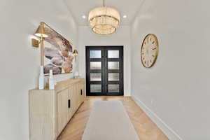 Foyer featuring an inviting chandelier, recessed lighting, baseboards, and french doors