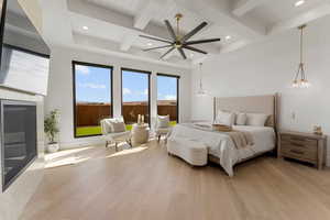 Bedroom featuring access to exterior, beamed ceiling, recessed lighting, and light wood-style floors