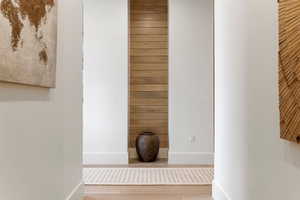 Interior space with wooden walls, baseboards, and wood finished floors