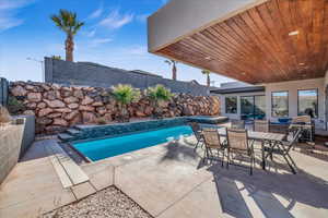 View of pool with an in ground hot tub, a patio area, a fenced backyard, and a fenced in pool