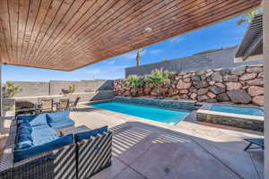 View of swimming pool with outdoor dining space, a fenced backyard, a fenced in pool, and a patio