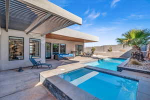 View of pool featuring an in ground hot tub, outdoor lounge area, fence, a fenced in pool, and a patio area